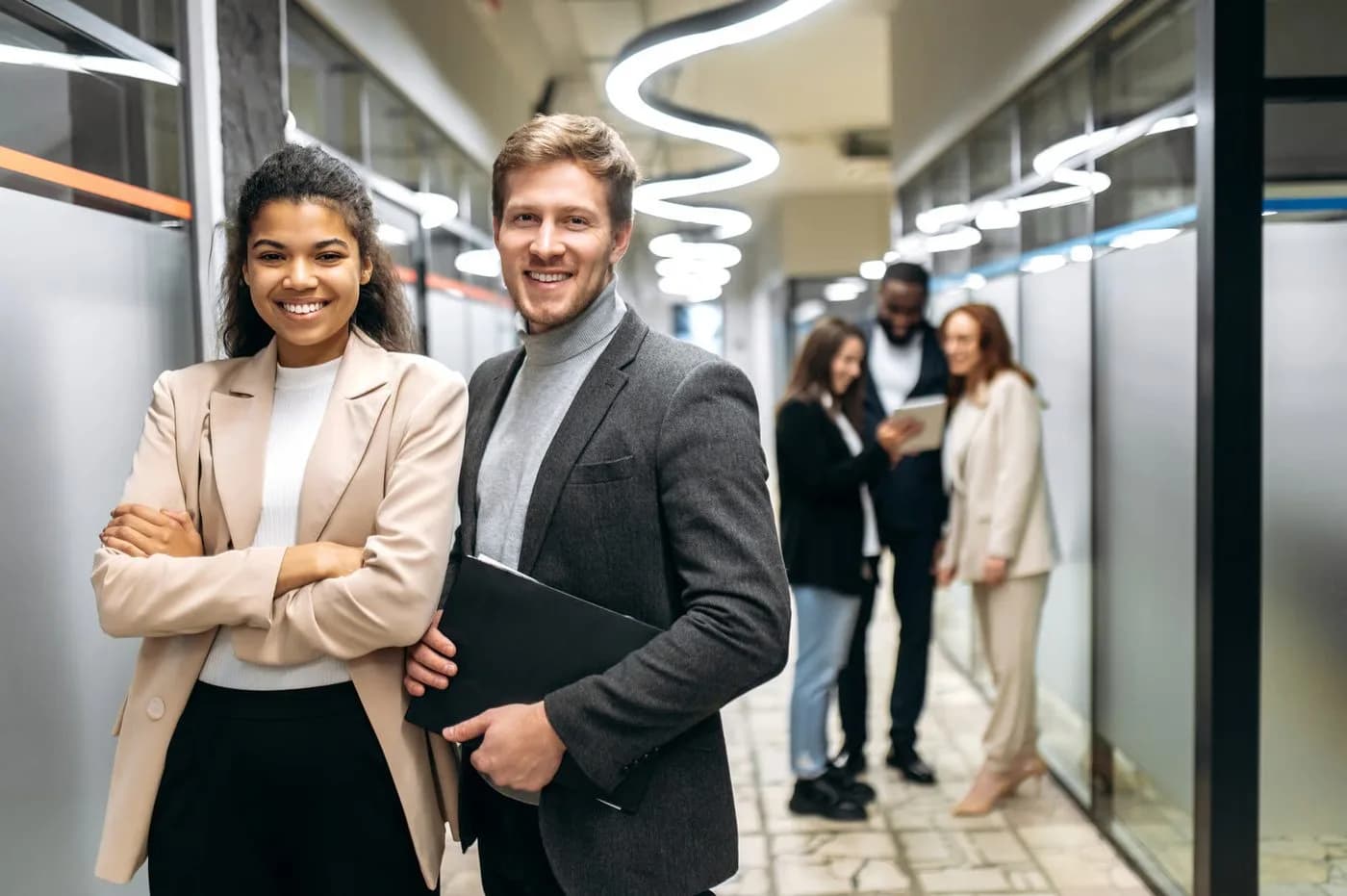 Colleagues talking in an office corridor
